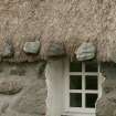 Detail of weights on thatch over window; 472a South Lochboisdale, South Uist.
