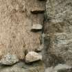 Detail of thatched roof beside chimney stack; 472a South Lochboisdale, South Uist.