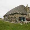 Side view of thatched cottage and chimney stack; 466 South Lochboisdale, South Uist.