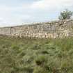 Walling on west side of estuary, view from north east. Note the lower, darker-coloured stone courses of the original quay wall.