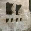 Interior. Distillery building, south range, engine house. Detail of square openings in wall which would have contained the bolts which held the engine fast and allowed the axle of the flywheel to connect with the engine (now gone).