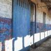 Interior. Stable Range. 3rd Floor. Detail of sliding door entrance to stalls from walkway.