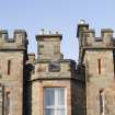 Exterior. Detail of castellations and chimney stacks on south elevation..