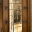 East transept. Glazed screen at south end, view through to east side of nave.