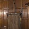 West withdrawing room. Detail of radiator with wall light above.