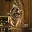 Chancel. Detail of carved angel on end of choir stall.