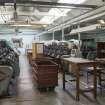 Interior. Ground floor. Frame flat no 1. View from north. Bentley of Loughborough's 'Bentley Cotton' knitting machine (left, ?early 1980s). The 'tubs' on the right were used to move 'cones' of yarn around the work area.