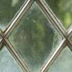 South window. Detail of writing etched on glass. (Image reversed for legibility.)