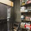 Storeroom. View of stepped access to toilet and shop fittings.