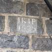 Detail of initials IKIP and date 1825 inscribed on wall to the left of the main entrance.