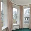 Detail of North West bay bedroom with curved window glass.