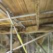 Interior. Ground floor. View of possible original joist from south west. Scaffolding installed to enable work on the building.