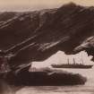 View of couple on rocks with ship in background, Durban, South Africa. 
Titled 'Bluff Rock'.  The cave rock was at the headland harbour entrance, but was dynamited in the 1940s. 
PHOTOGRAPH ALBUM NO:11 KIRSTY'S BANFF ALBUM