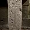 Obliquely lit view of medieval cross slab.