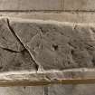 Obliquely lit view of carved stone (with scale).