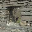 West range, north end, view looking through window on west wall to fireplace beyond