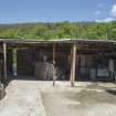 Open shed at north end of courtyard, view from south. Lime pit to left