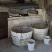Interior. North end of courtyard. Lime pit, view showing half wooden barrel mixing vessels and two-handled buckets
