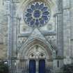 Main north west entrance with rose window and angels, view from west