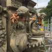 Fountain dismantled to lower level, detail of festoon between mermaids with flowing urns