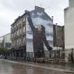 General view showing Billy Connolly mural (Jack Vettriano) from north east.