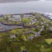 Oblique aerial view from west of Midd Engine and East Engine Quarries, Easdale village, central spoil, walls and workings and Harbour