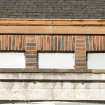Detail of coloured brick pattern on clearstory level above loggia.