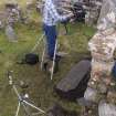 Church interior. HES Photographer Steve Wallace recording the late medieval graveslab