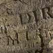 Detail of carved lettering on south wall of cave