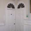 Ground floor. Stair hall, view of pair of doors with arched fanlights.