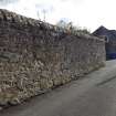 A view from the NE looking down Ashlar Lane. The boulder bearing the incised cross is build into the foot of the wall on the left.