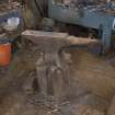 View of anvil sitting on tree trunk base