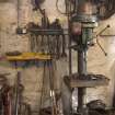 View of tools and vertical drill on west wall