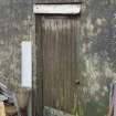 Detail of rear door with branding iron marks (based on croft address) and used to identify machinery and other objects belonging to the croft/crofter
