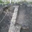 WB NE area. Revetment wall [247] leading up to N corner of building (Wall [245]) facing SW