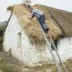 View of cottage from south west showing thatching in progress.