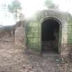 N facing shot of Ice house inner structure and section of soil mound