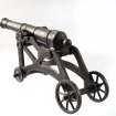 Cast iron model of a cannon.
