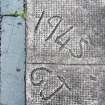 Detail view of graffiti on pavement.