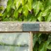Detail of door plaque on greenhouse, Walled Garden, Housedale, Dunecht House.