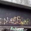 A view of some of the graffiti on the steel beams that support the decking of the footbridge.