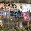 Graffiti on the inner face of the boundary wall on the west side of the dock area.
