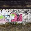 Graffiti on the inner face of the boundary wall on the west side of the dock area.