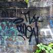 Graffiti on the inner face of the boundary wall on the west side of the dock area.