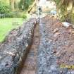 Archaeological evaluation, View of service trench nearing completion, Mitchell House, Dullatur