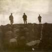 Photograph of three men at Hillhead Broch. 