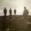 Photograph of four men at Hillhead Broch. 