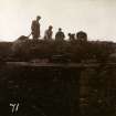 Photograph of five men working on top of Hillhead Broch. 