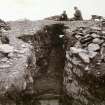 Photograph of Sir F. T. Barry at the entrance passage to Norwall Broch.