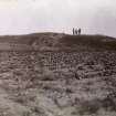 Distant photograph of men at Kilminster Broch (mound).